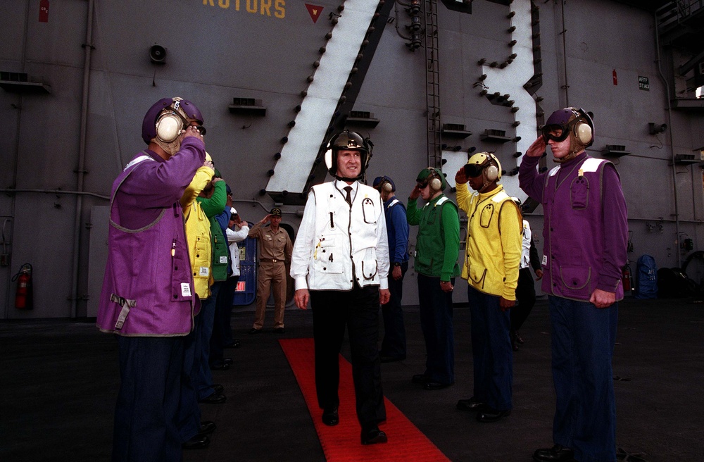 Secretary Cohen is piped  through the sideboys as he departs the USS George Washington.