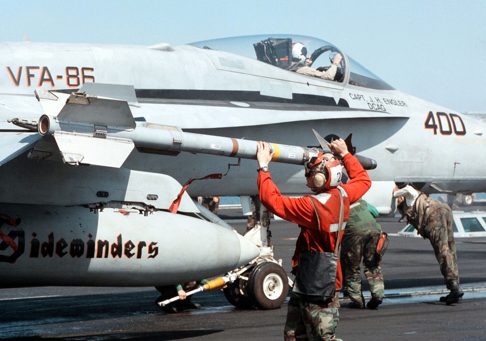 Lance Cpl. Leander Pickens arms an AIM-9 Sidewinder missile on a F/A-18C Hornet. Lance Cpl. Leander Pickens arms an AIM-9 Sidewinder missile on a F/A-18C Hornet.