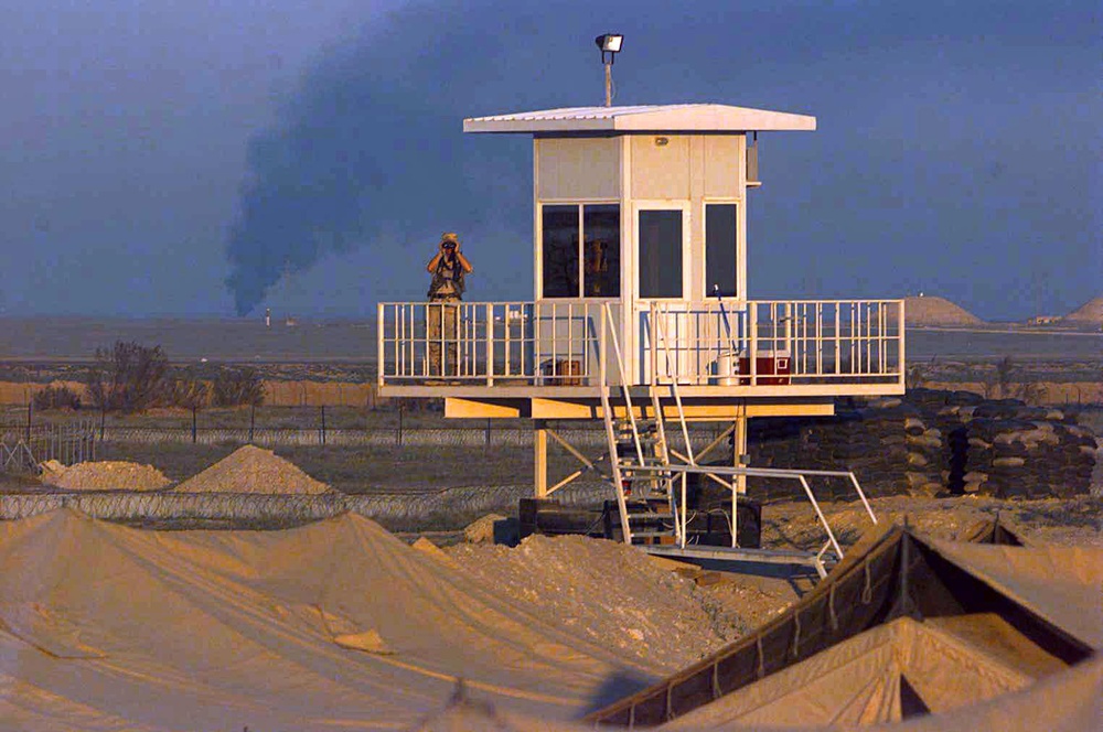 A security forces specialist scans the horizon at an operating base in Southwest Asia.