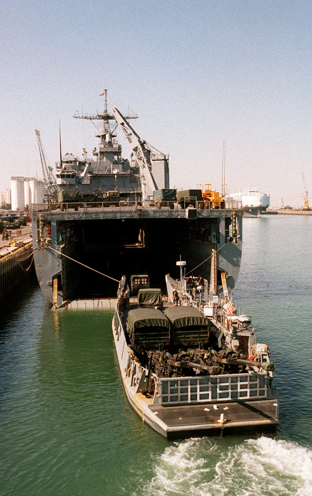 A U.S. Marine Corps ambulance drives into the well deck of the USS Ashland in Kuwait City.