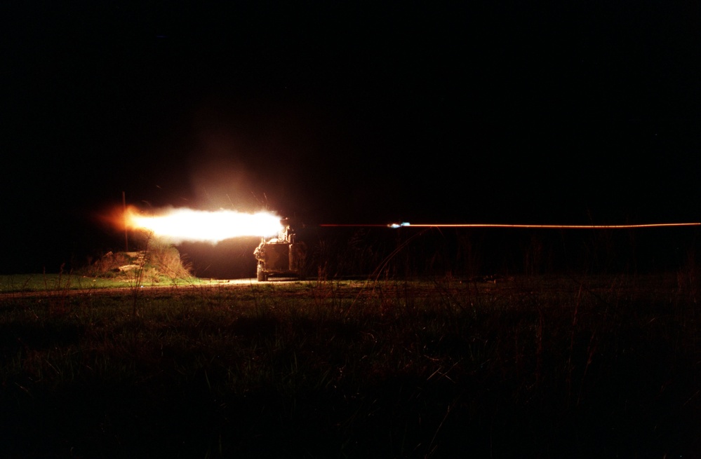 The blast from the rocket motor lights up the night as U.S. Marines fire a TOW missile.