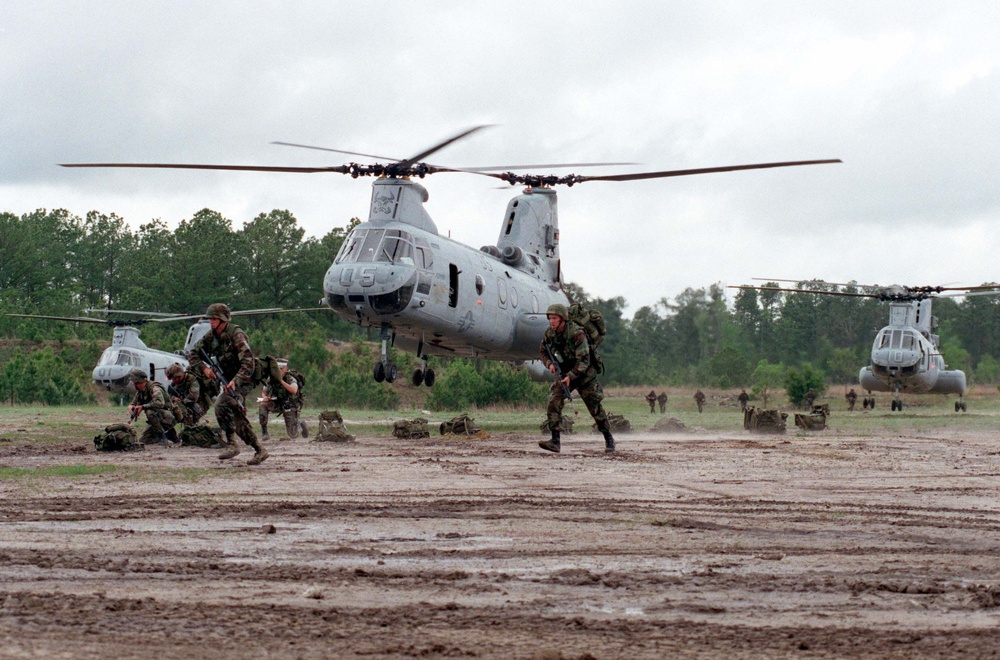U.S. Marines move away from CH-46 Sea Knight helicopters at Landing Zone Coot.