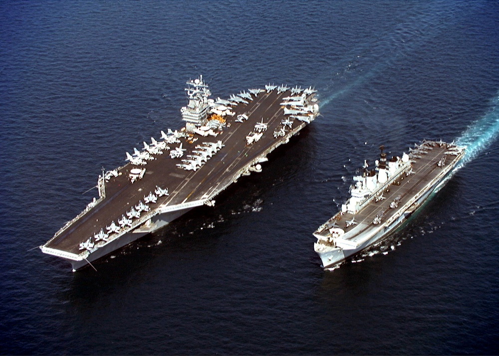 USS John C. Stennis steams alongside HMS Illustrious in the Persian Gulf.