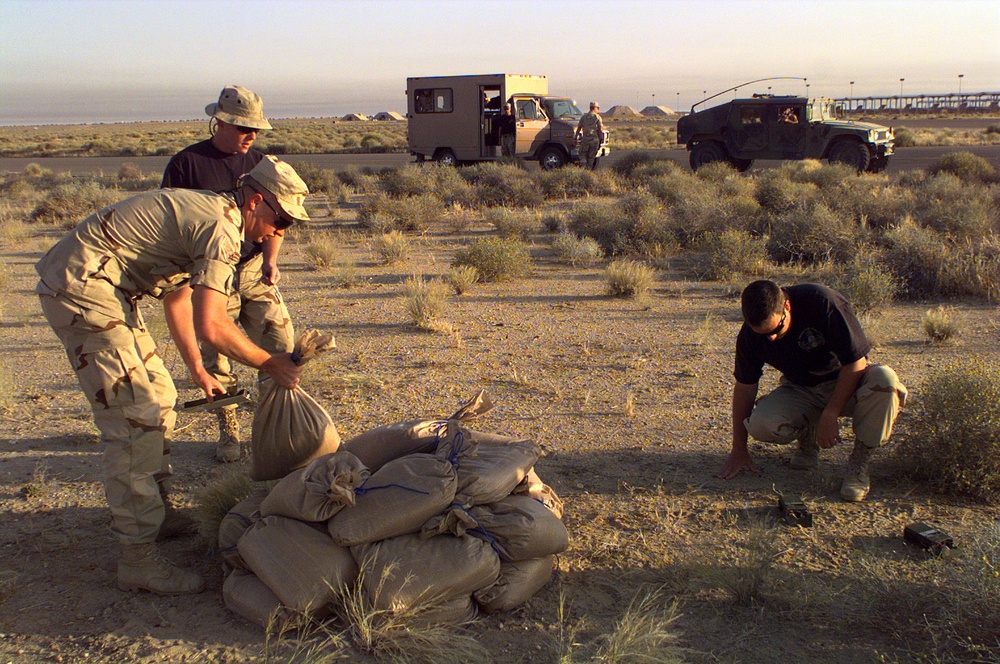 Explosive ordinance disposal experts prepare to detonate an unexploded bomblet.