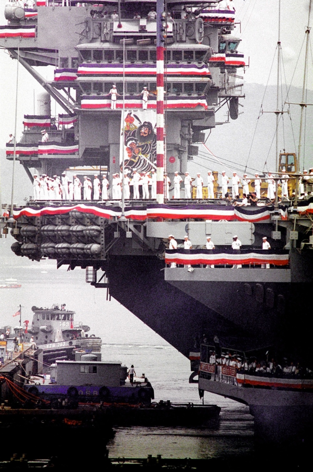 Sailors line the deck of the USS Independence CV 62 as it leaves its homeport in Japan.