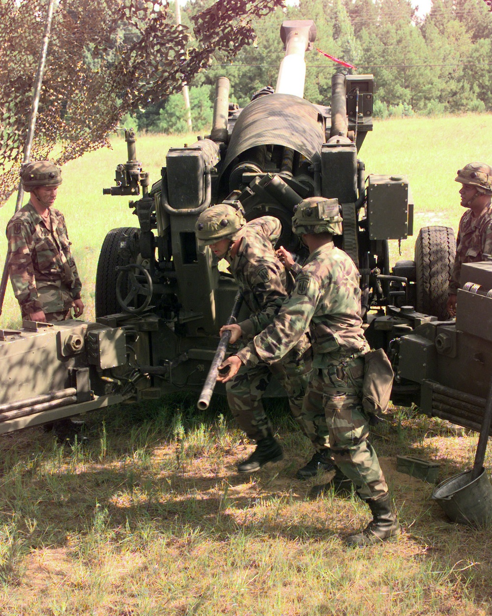 Soldiers from Charlie Company prepare to fire a 155mm howitzer.