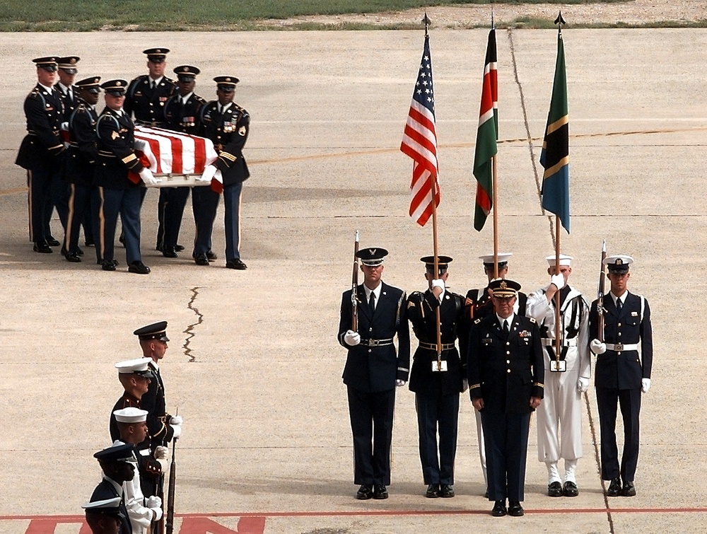 Soldiers carry the remains of an embassy bombing victim to a ceremony at Andrews.