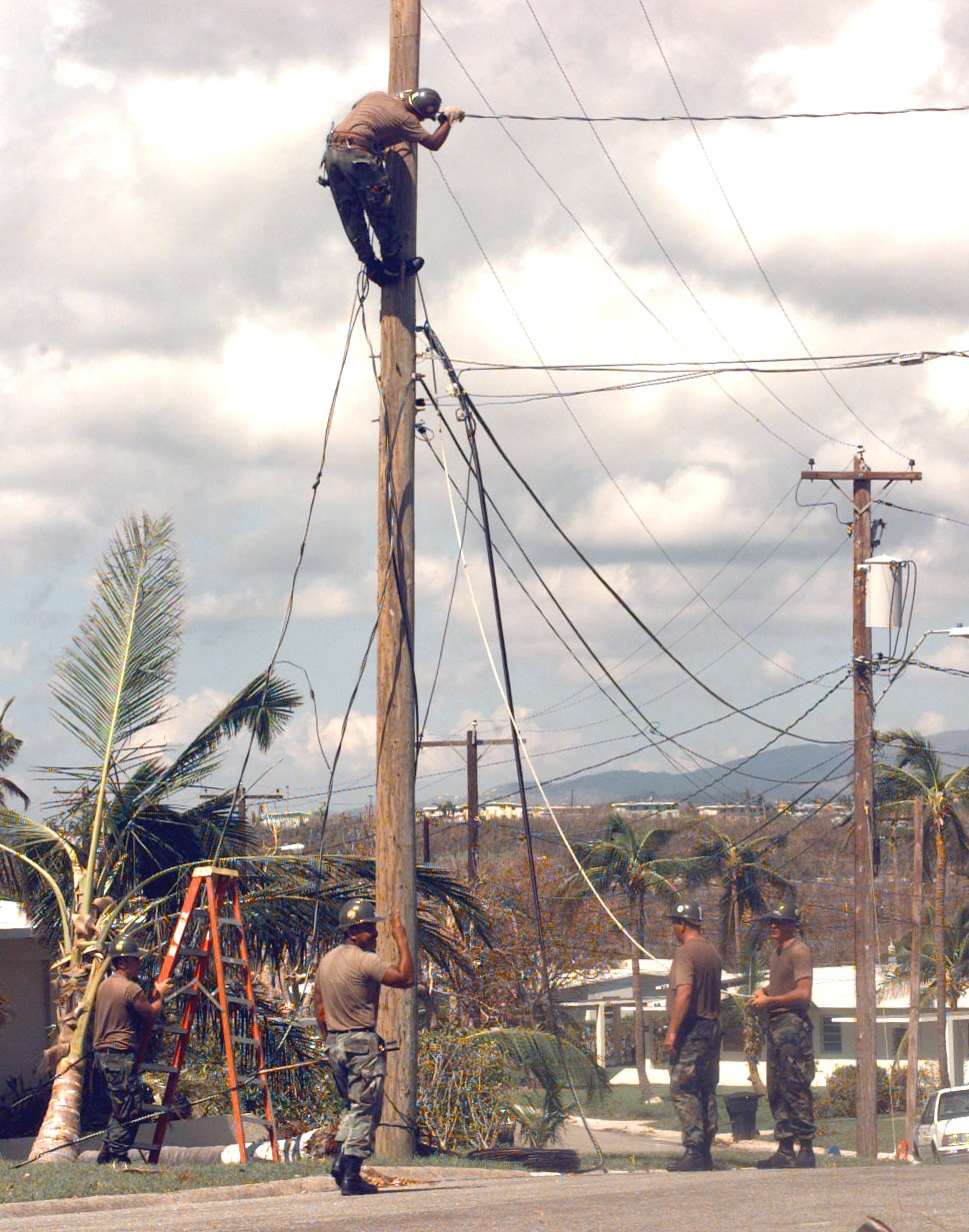 U.S. Navy SeaBees work on power lines in the housing area of Naval Station Roosevelt Roads.