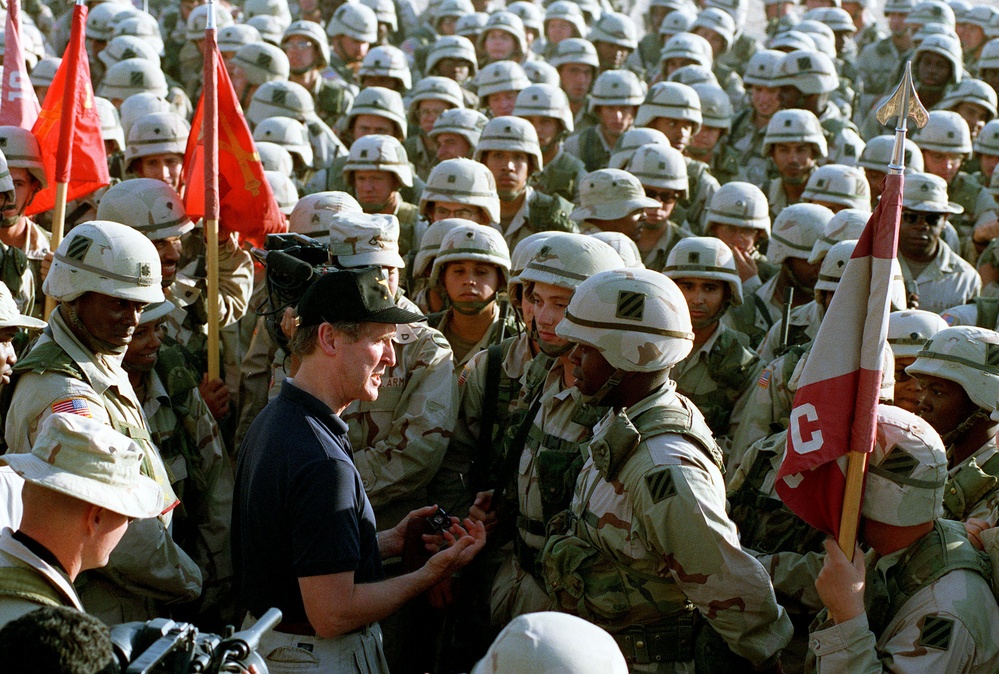Secretary Cohen mingles among the crowd of U.S. soldiers at Udairi Range, Kuwait.