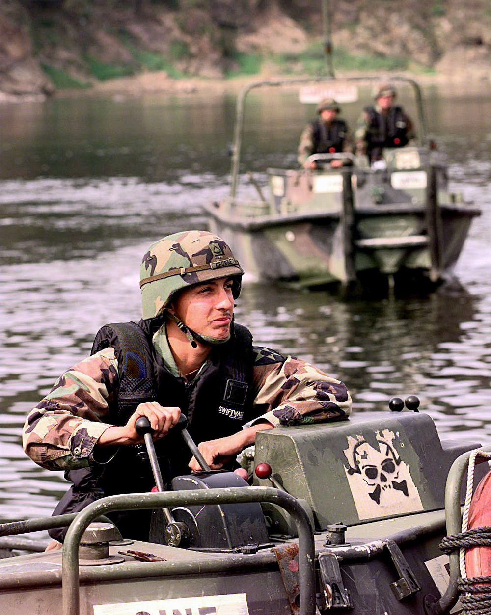 Pfc. George Damian operates the throttle of his Bridge Erection Boat during a training exercise.