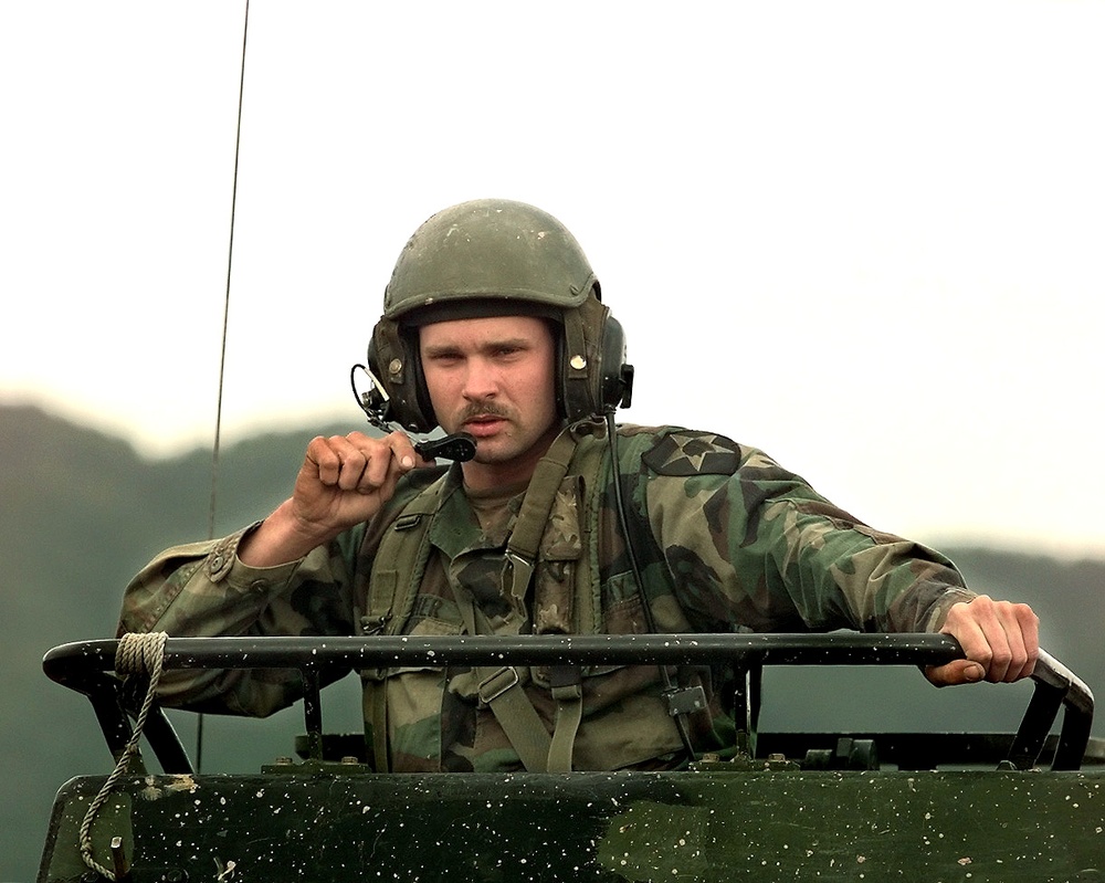 Sgt. Mike Stacher guides his M-270 Multiple Launch Rocket System at Camp Red Cloud.