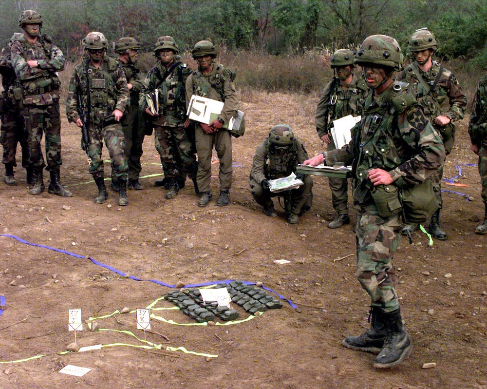 U.S. Army 1st Lt. Thomas Nelson uses a terrain model as he briefs the platoon commanders.