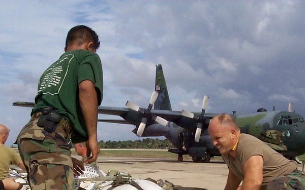 U.S. and Netherlands service men prepare pallets of rice sacks for victims of Hurricane Mitch.