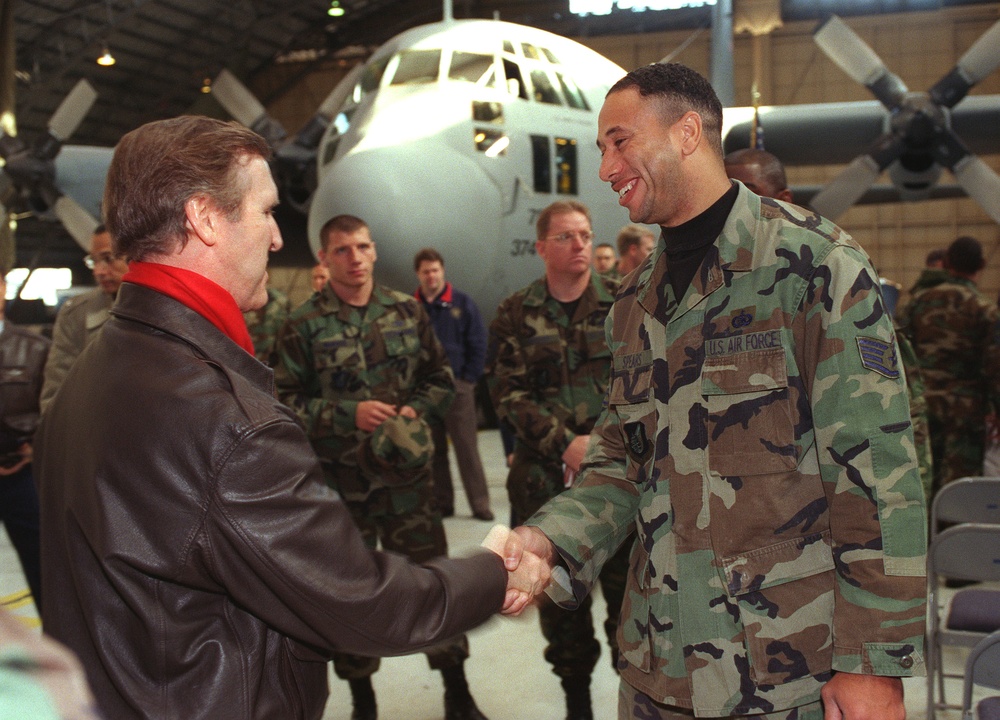 Secretary Cohen is greeted by Staff Sgt. Spear of the U.S. Air Force 374th Airlift Wing.