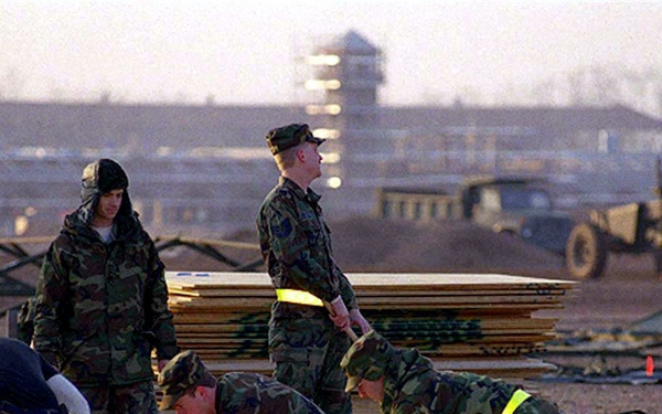 Engineers construct a plywood floor for a tent at Aviano Air Base, Italy.