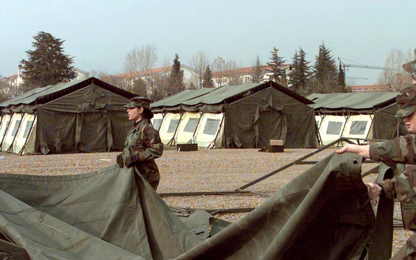U.S. Air Force civil engineering and services people set up a tent at Aviano Air Base.