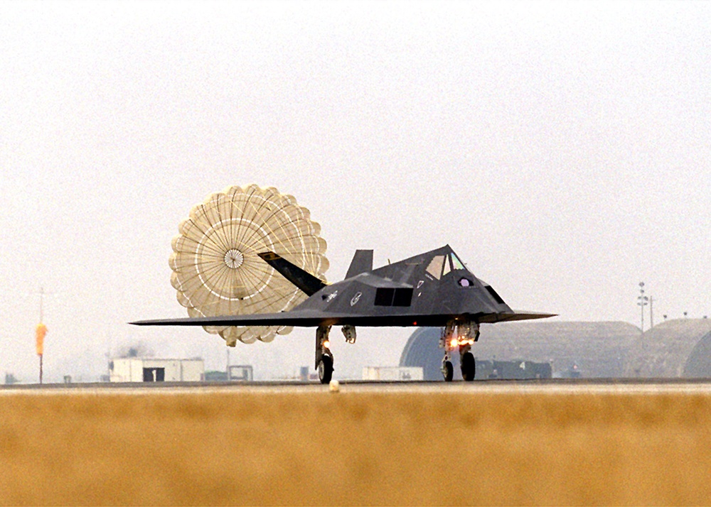 An F-117 Nighthawk uses a parachute to help it slow down after landing at Aviano Air Base.