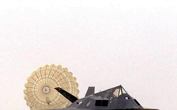An F-117 Nighthawk uses a parachute to help it slow down after landing at Aviano Air Base.