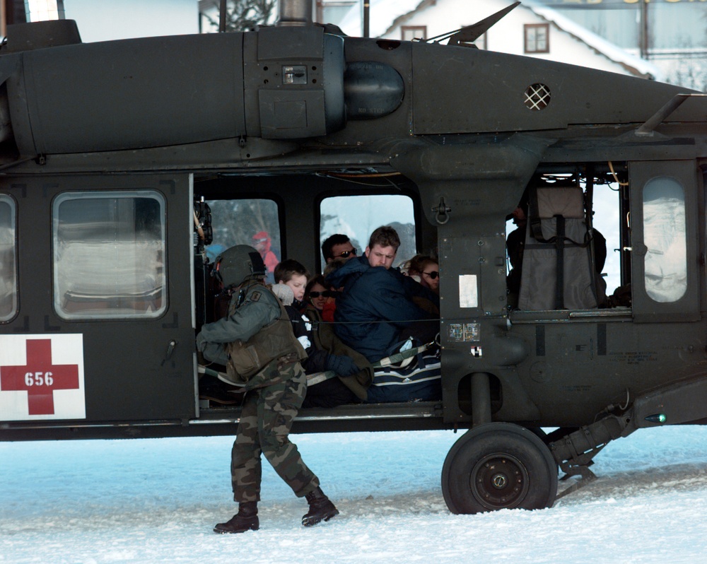Sgt. Mathis checks the door of a Blackhawk as the crew prepares to evacuate avalanche victims.
