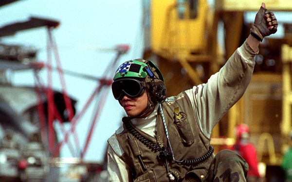 Petty Officer 3rd Class Richard Lim gives a thumbs up on the flight deck of the USS Carl Vinson.