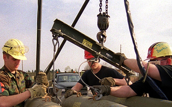 Armament personnel load bombs at Aviano for NATO Operation Allied Force.