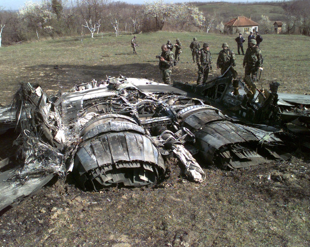A U.S. Army team surveys the wreckage of a Former Republic of Yugoslavia MiG-29 jet fighter.