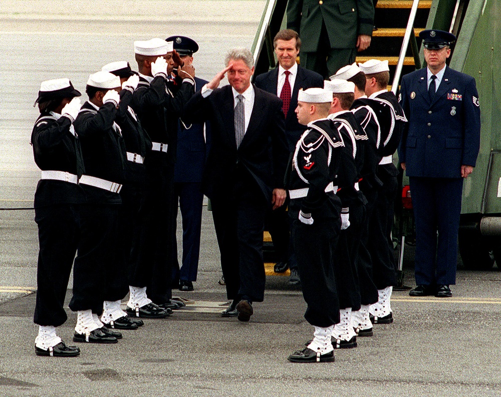 President Clinton goes through the sideboys welcoming him aboard Norfolk Naval Station.