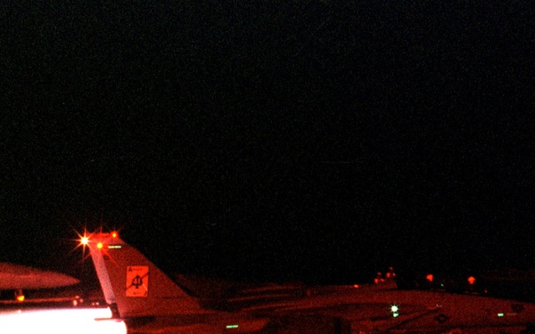 A U.S. Navy F-14 Tomcat goes to full afterburner as it prepares to launch.