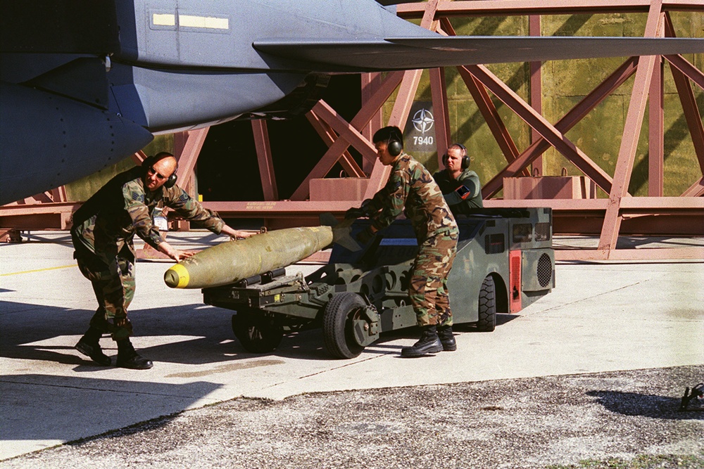 U.S. Air Force airmen load bombs onto an F-15 Fighter at Aviano Air Base.