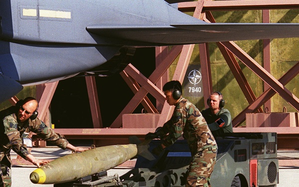 U.S. Air Force airmen load bombs onto an F-15 Fighter at Aviano Air Base.