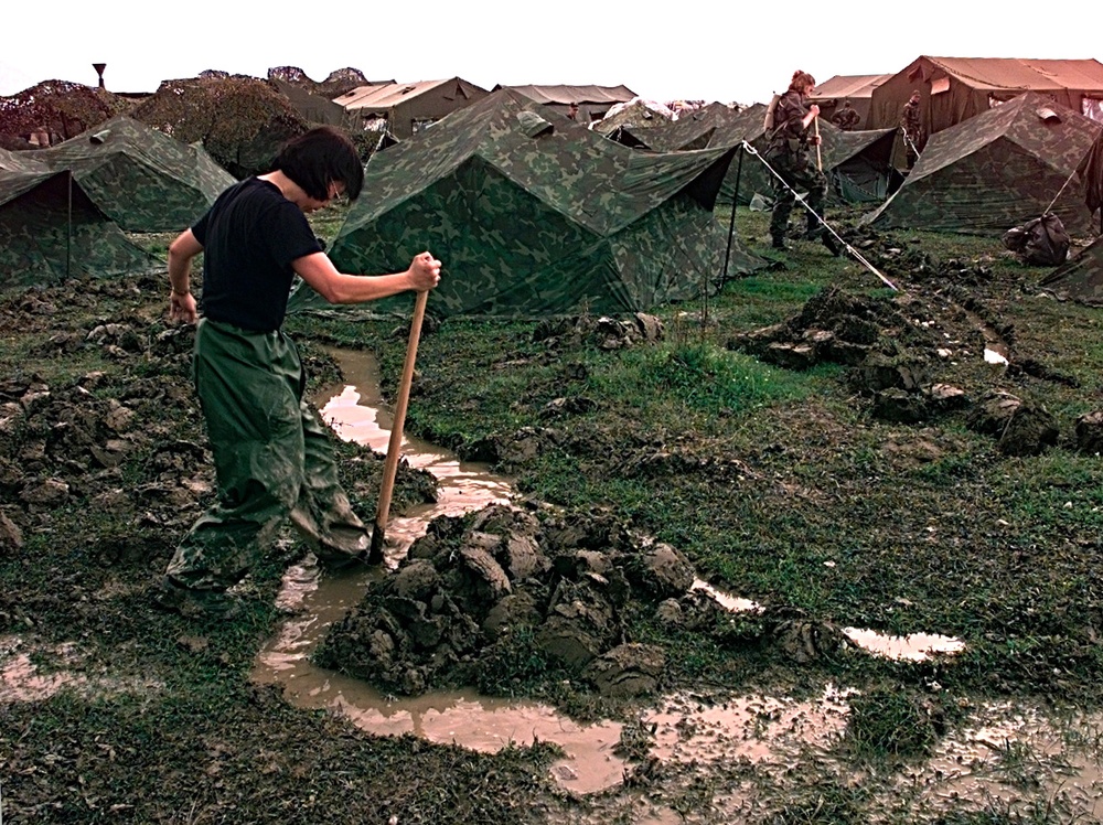 Tech. Sgt. Theresa Penn digs drainage ditches at the U.S. encampment at Tiranë, Albania.