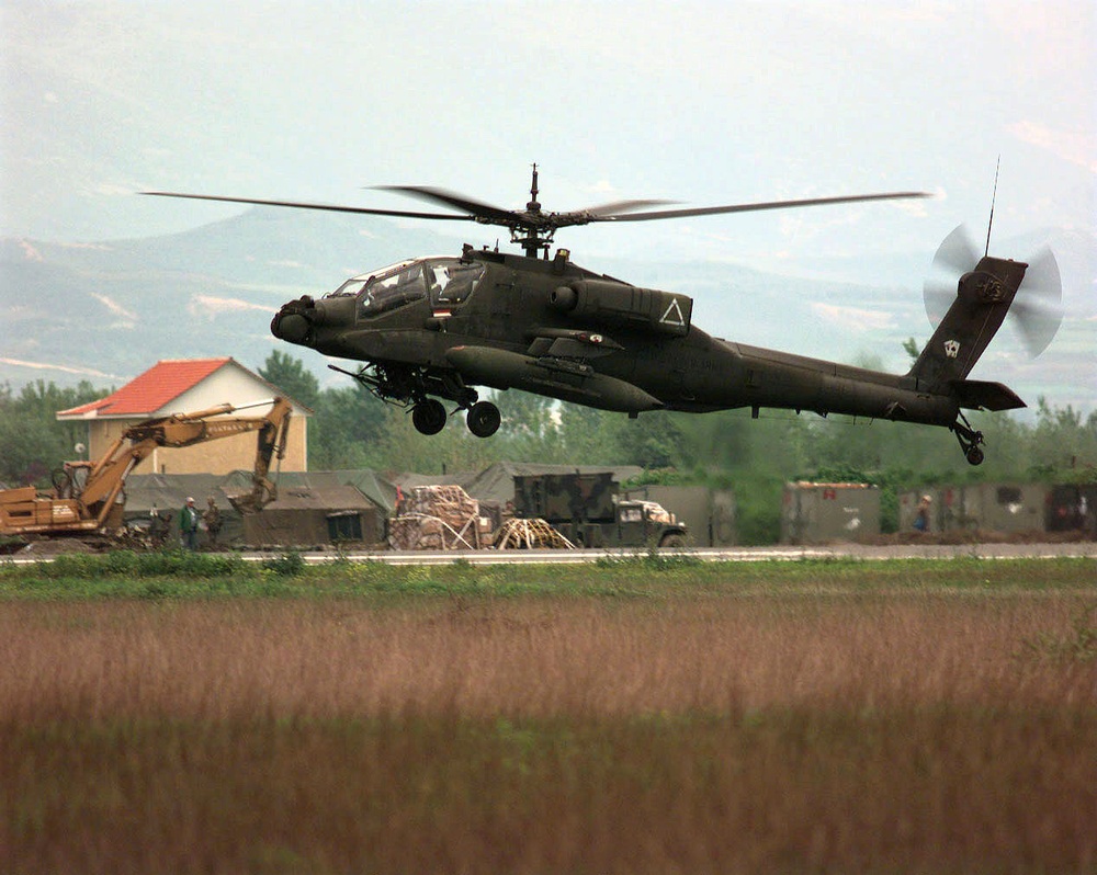 A U.S. Army AH-64A Apache attack helicopter comes in for a landing at Tirana, Albania.