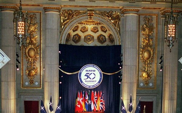 Representatives of the 19-member NATO nations are seated during the ceremony.