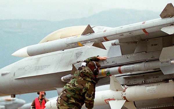 A crew chief from the 78th Fighter Squadron makes a final inspection of an F-16 Fighting Falcon.