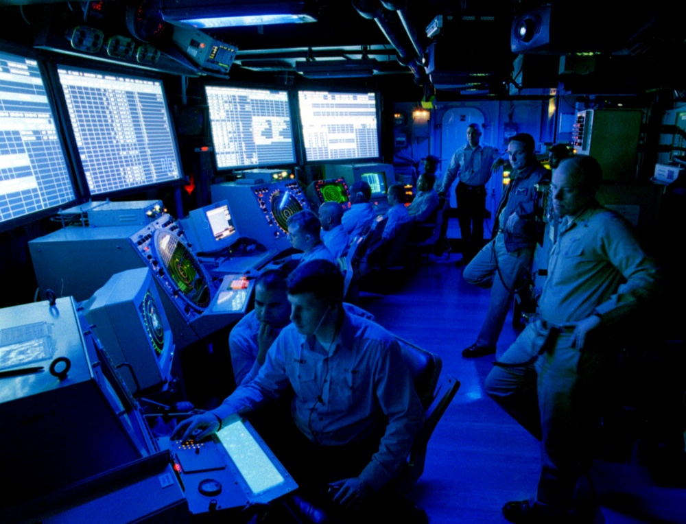 U.S. Navy air traffic controllers man the radar screens on board the USS Theodore Roosevelt.