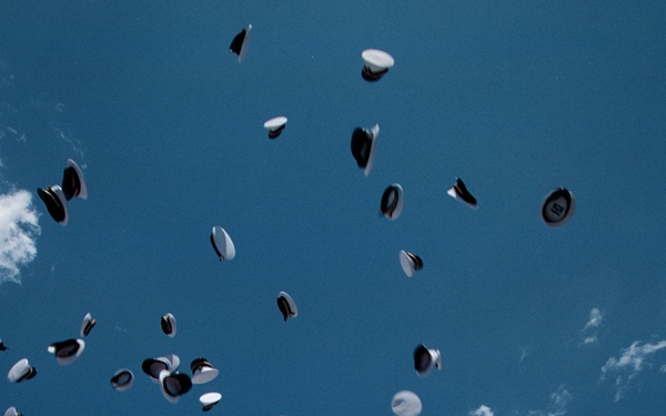 Graduates of the United States Naval Academy Class of 1999 keep the &quot;hat toss&quot; tradition alive.
