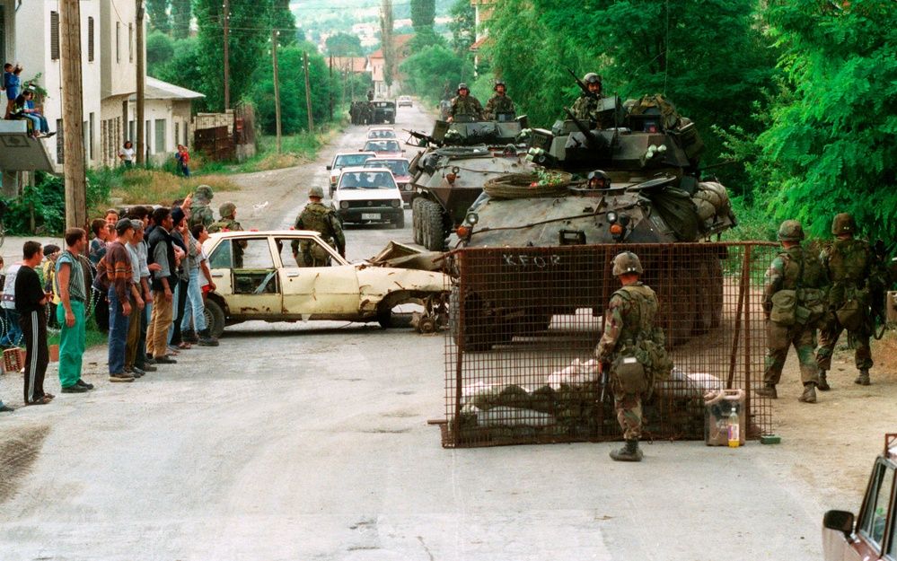 U.S. Marines set up a road block to check for weapons near the village of Koretin, Kosovo.