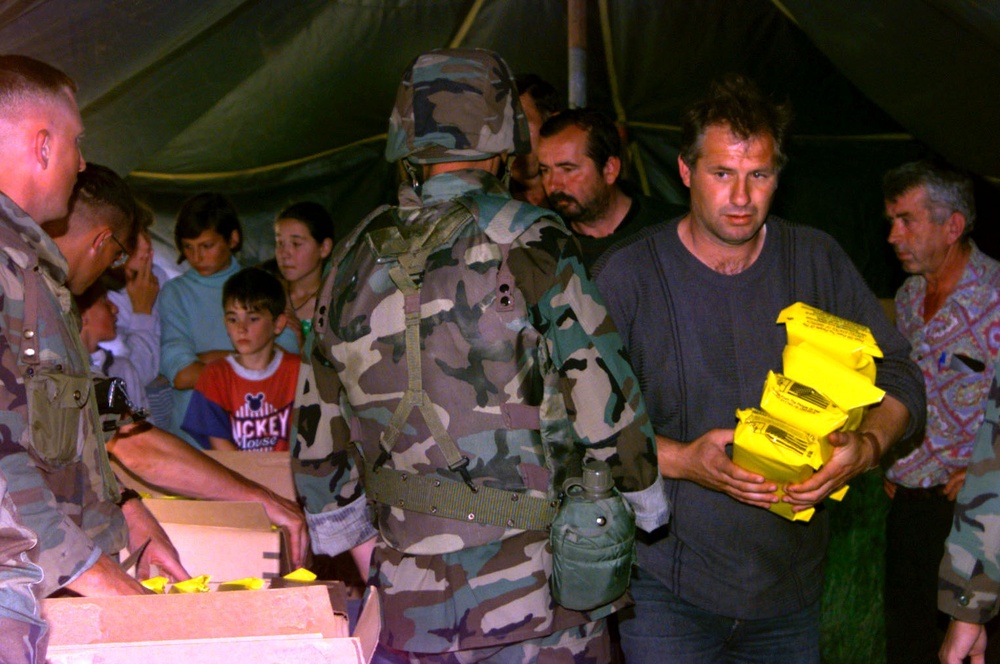 Serbian villagers receive Humanitarian Daily Rations from U.S. Marines in Kosovo.