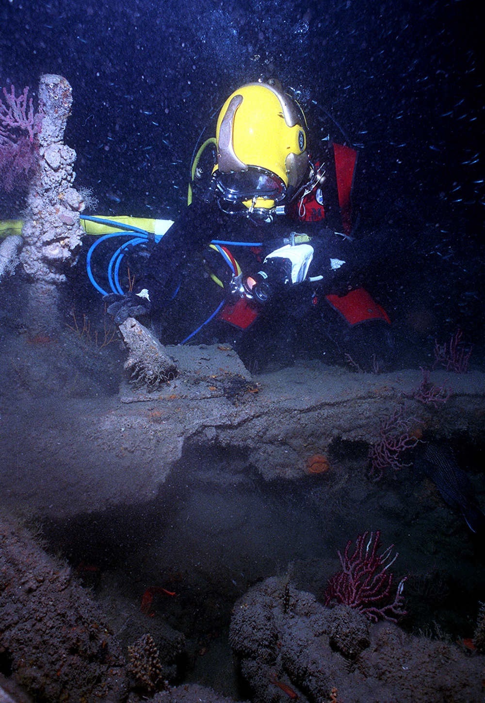 Cmdr. Philip  Beierl inspects an artifact on the USS Monitor 240 feet below the ocean's surface.