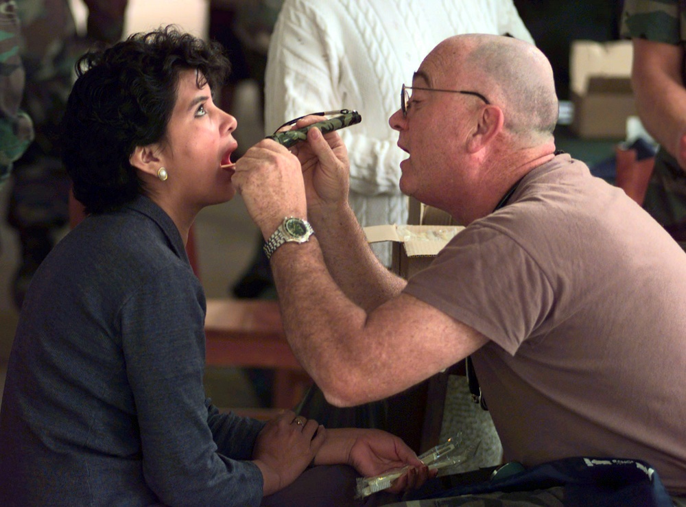 Capt. Larry Roszell examines the throat of one of the patients in Villamontes, Bolivia.