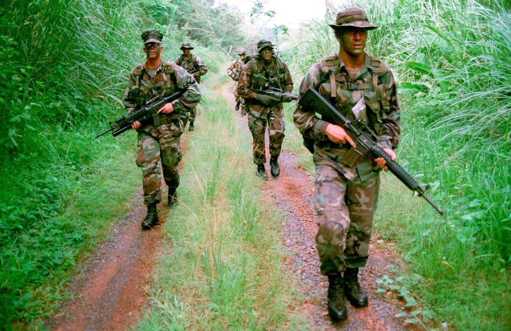 U.S. Marines search for trails left by intruders during a jungle patrol on Fort Howard, Panama.