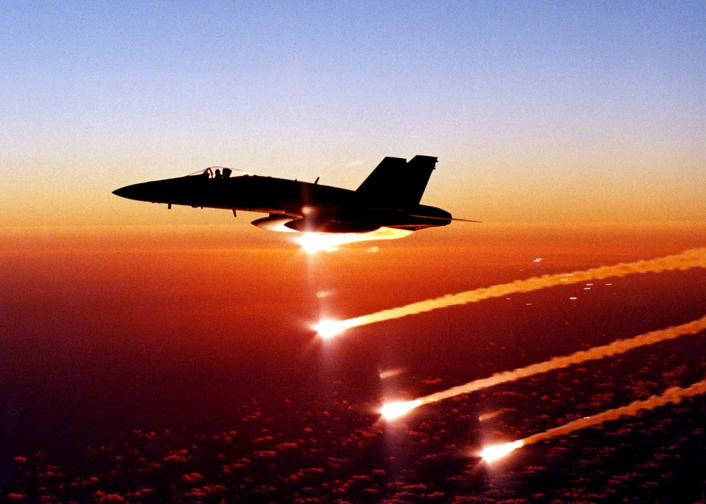 Lt. Reggie Hamon expends flares from his F/A-18C Hornet over the Pacific Ocean.
