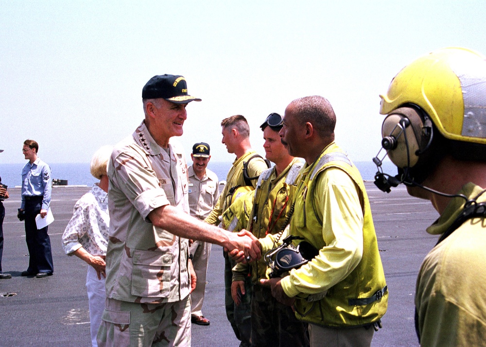 Gen. Shelton shakes hands with crew members on the flight deck of the USS Theodore Roosevelt.
