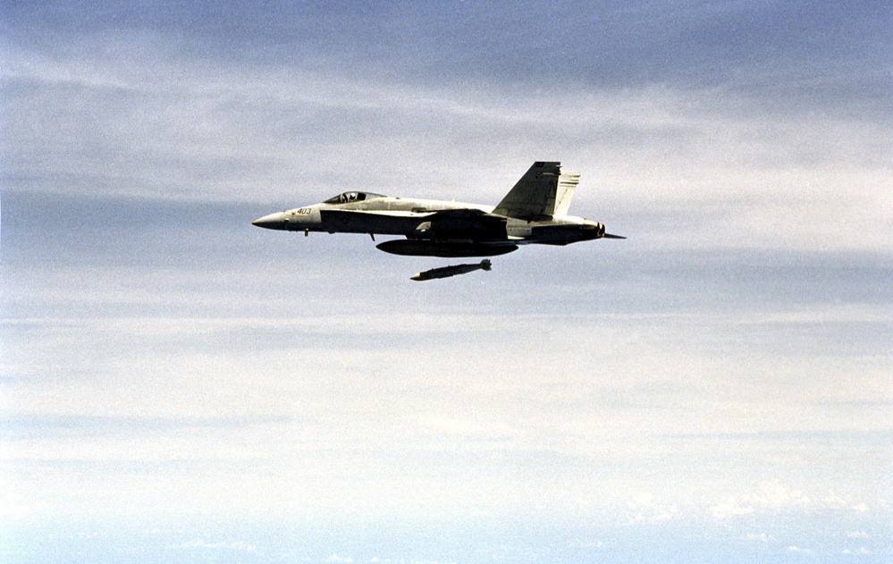 A U.S. Navy F/A-18C Hornet releases a Joint Direct Attack Munitions.