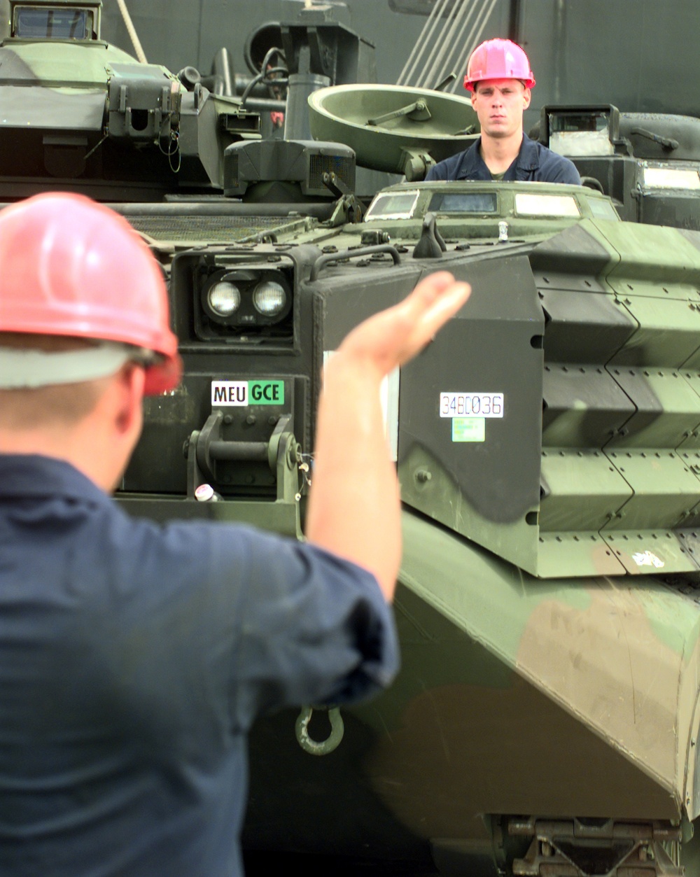 The driver of a U.S. Marine Corps Amphibious Assault Vehicle is guided as the tracked vehicle is off loaded in Gladstone, Australia.