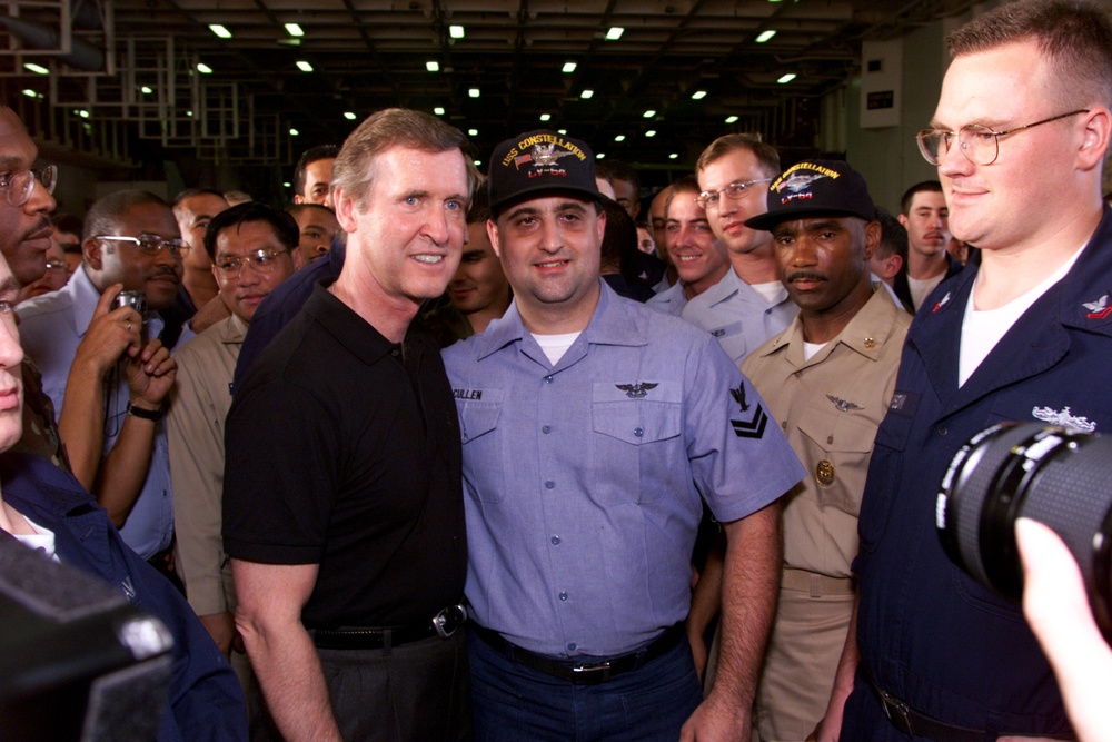 Secretary Cohen poses for photos with crew members of the aircraft carrier USS Constellation.