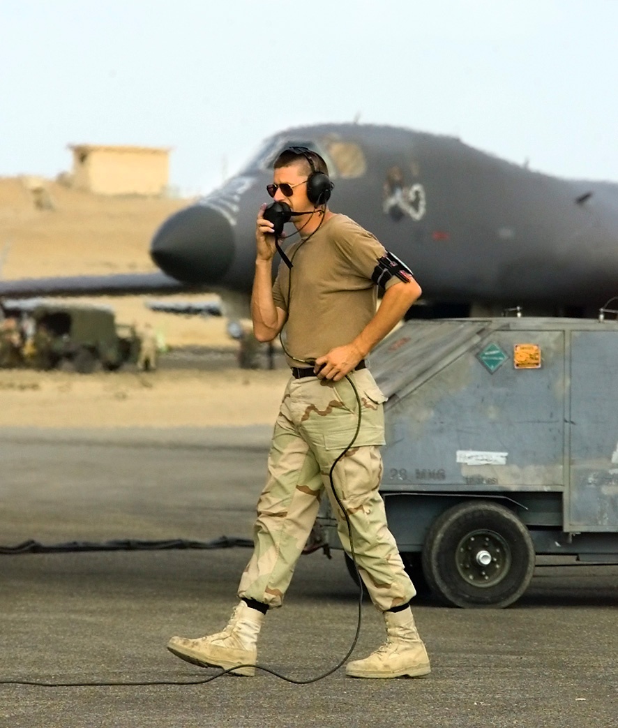 A B-1B Lancer bomber crew chief talks to the air crew in the plane on the flight line at Cairo West Air Base, Egypt.