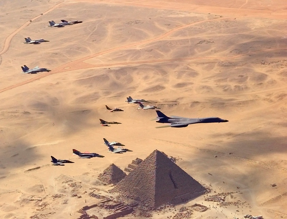 A B-1B Lancer bomber leads a flight of Egyptian, French, Greek, Italian and U.S. aircraft over the Great Pyramids.