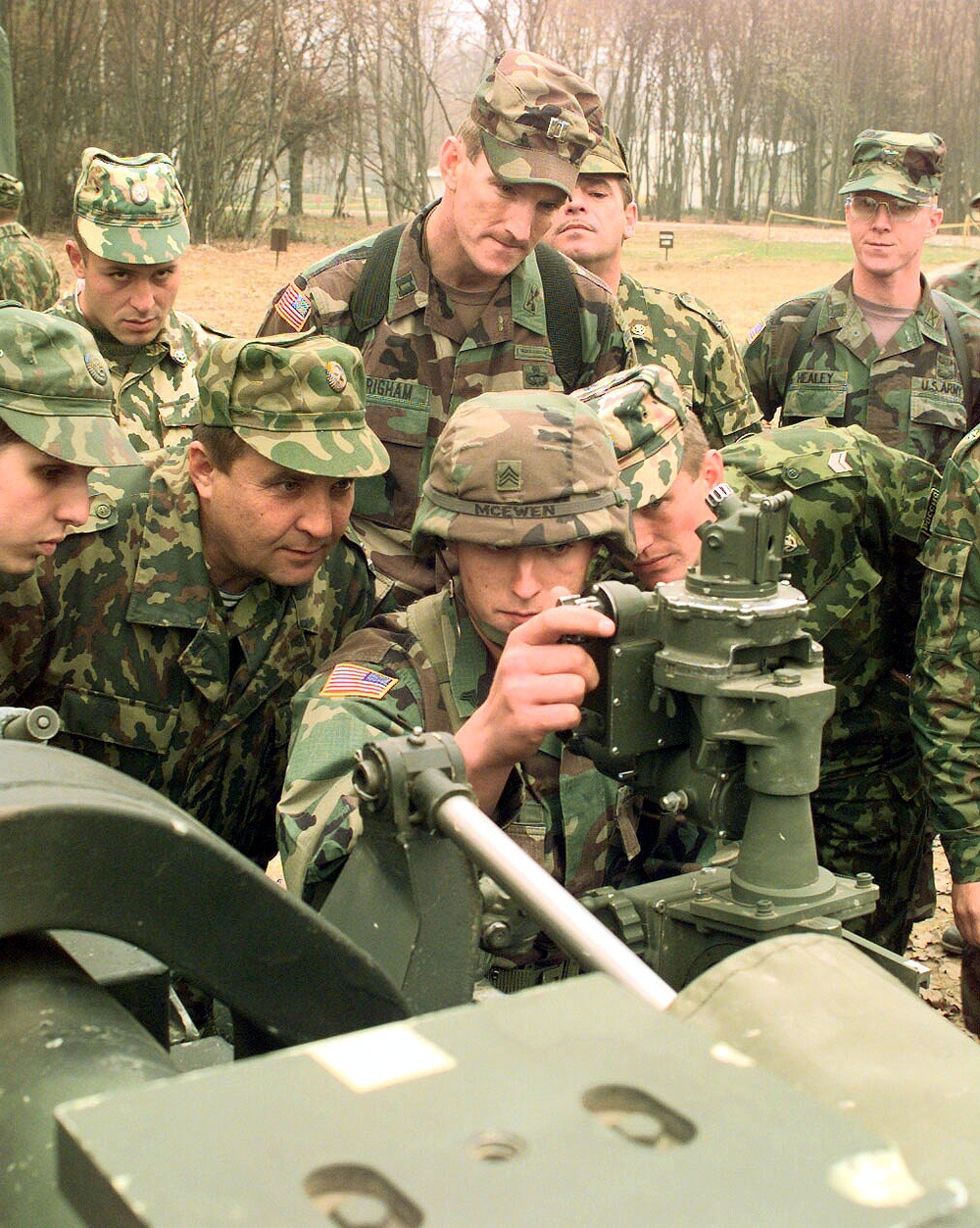 Sgt. Thomas B. McEwen explains the M-137A1 Panoramic Telescope to members of the Russian Separate Airborne Brigade.