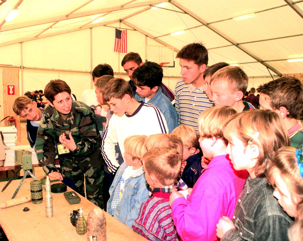 Children from Bosnia and Herzegovina listen to a translator explain the hazards of anti-personnel mines during Kids' Day.